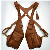 Brown leather harness vest with multiple pockets and brass hardware, adjustable fit.