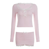 Light pink long sleeve crop top and mini skirt set with lace trim and ribbon accents.