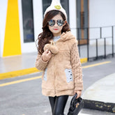 Girl wearing a beige faux fur hooded jacket with teddy bear pockets and cable knit sleeves