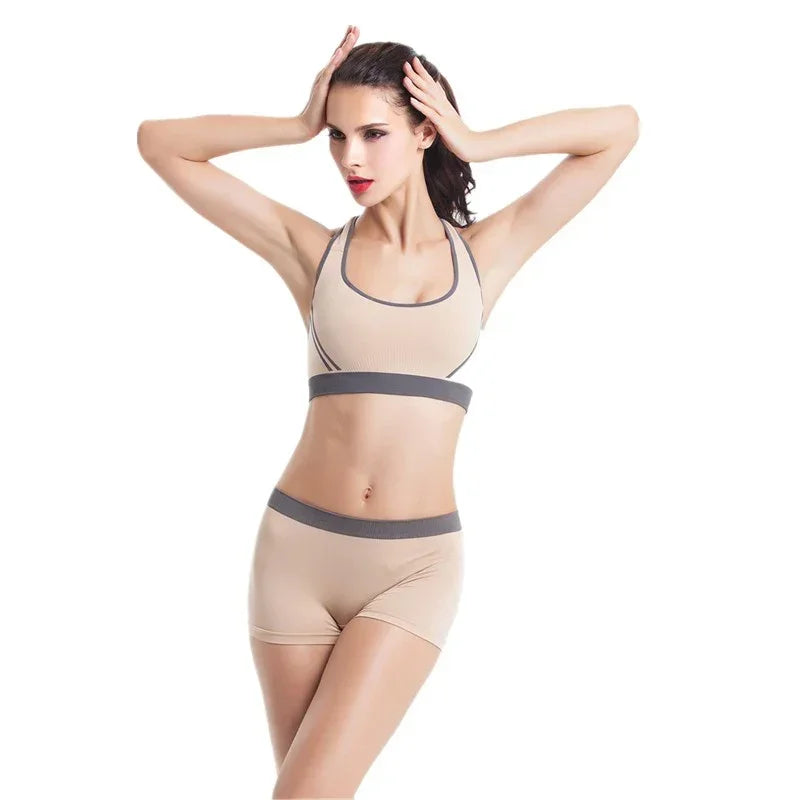 Woman modeling beige seamless sports bra and shorts set with gray trim, fitted and sporty style