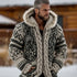 Man wearing a chunky knit hoodie with fur-trimmed hood, Nordic pattern, relaxed fit, in gray tones