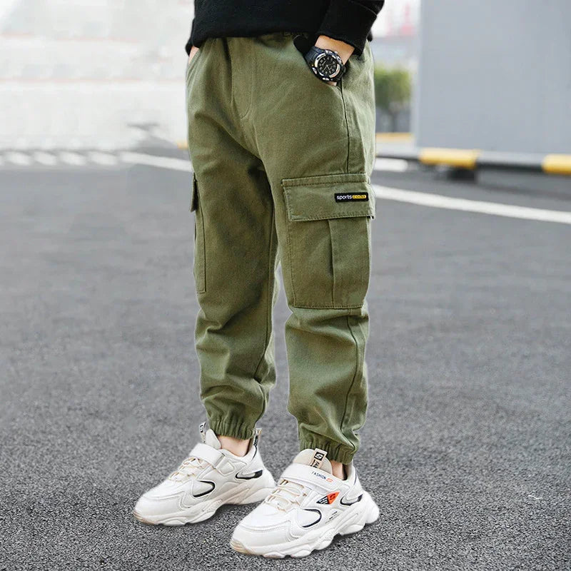 Olive green cargo jogger pants with side pockets, relaxed fit, and elastic cuffs.