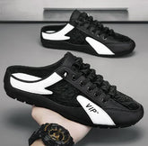 Black and white slip-on sneakers with mesh upper, low-profile fit, and lace-up design