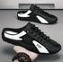 Black and white slip-on sneakers with mesh upper, low-profile fit, and lace-up design