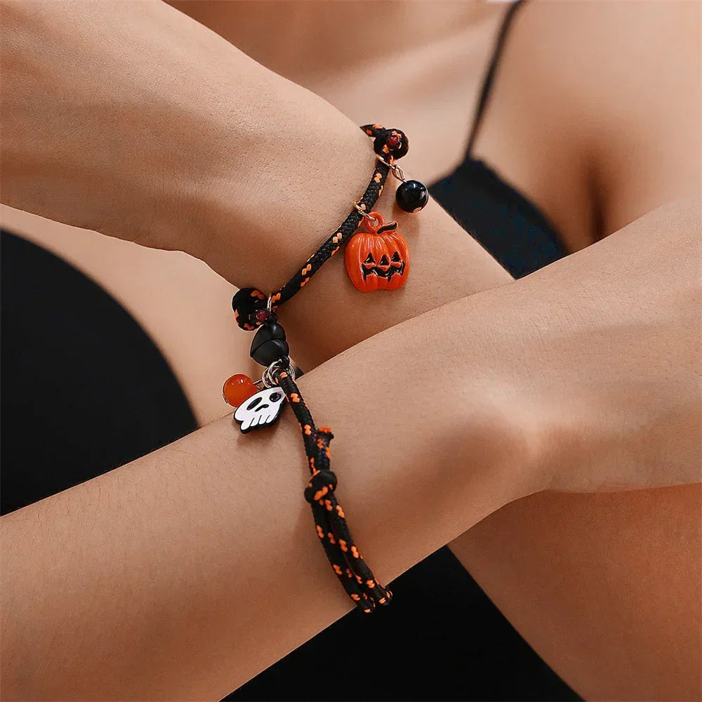 Black and orange braided bracelet with pumpkin and ghost charms, adjustable fit, Halloween style