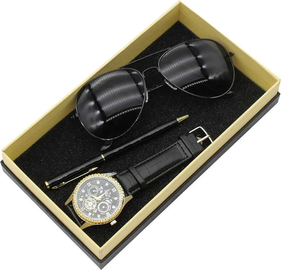 Men's accessory gift set with black aviator sunglasses, gold watch with black leather strap, and black pen