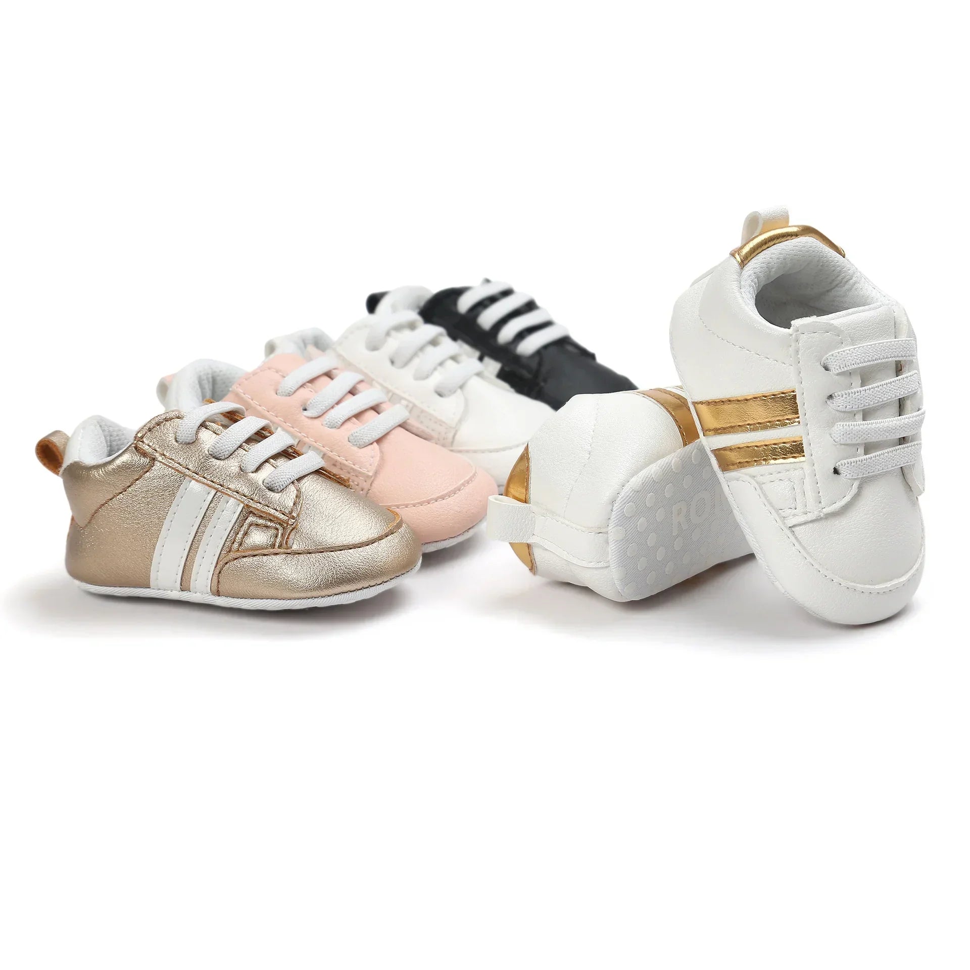 Assorted baby sneakers in gold, pink, black, and white with metallic accents and soft soles