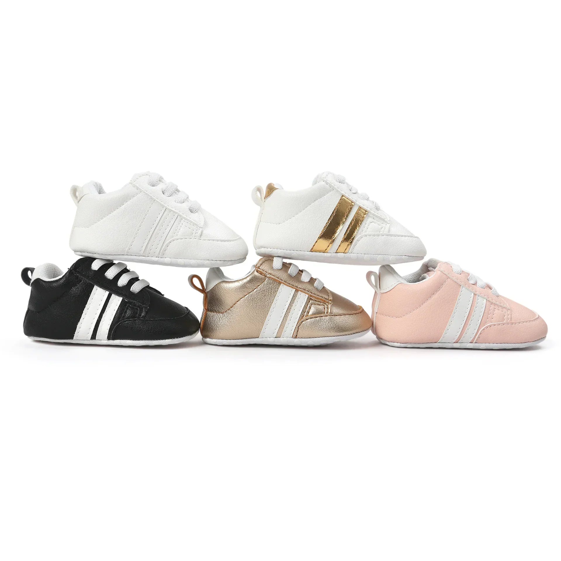 Five pairs of baby sneakers in black, white, gold, and pink with lace-up style and soft soles.