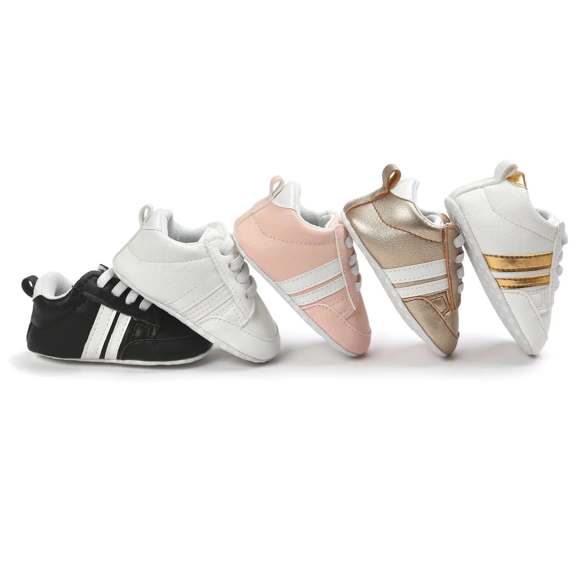 Assorted baby sneakers in black, white, pink, gold, and white with metallic stripes, faux leather, lace-up, sporty fit.