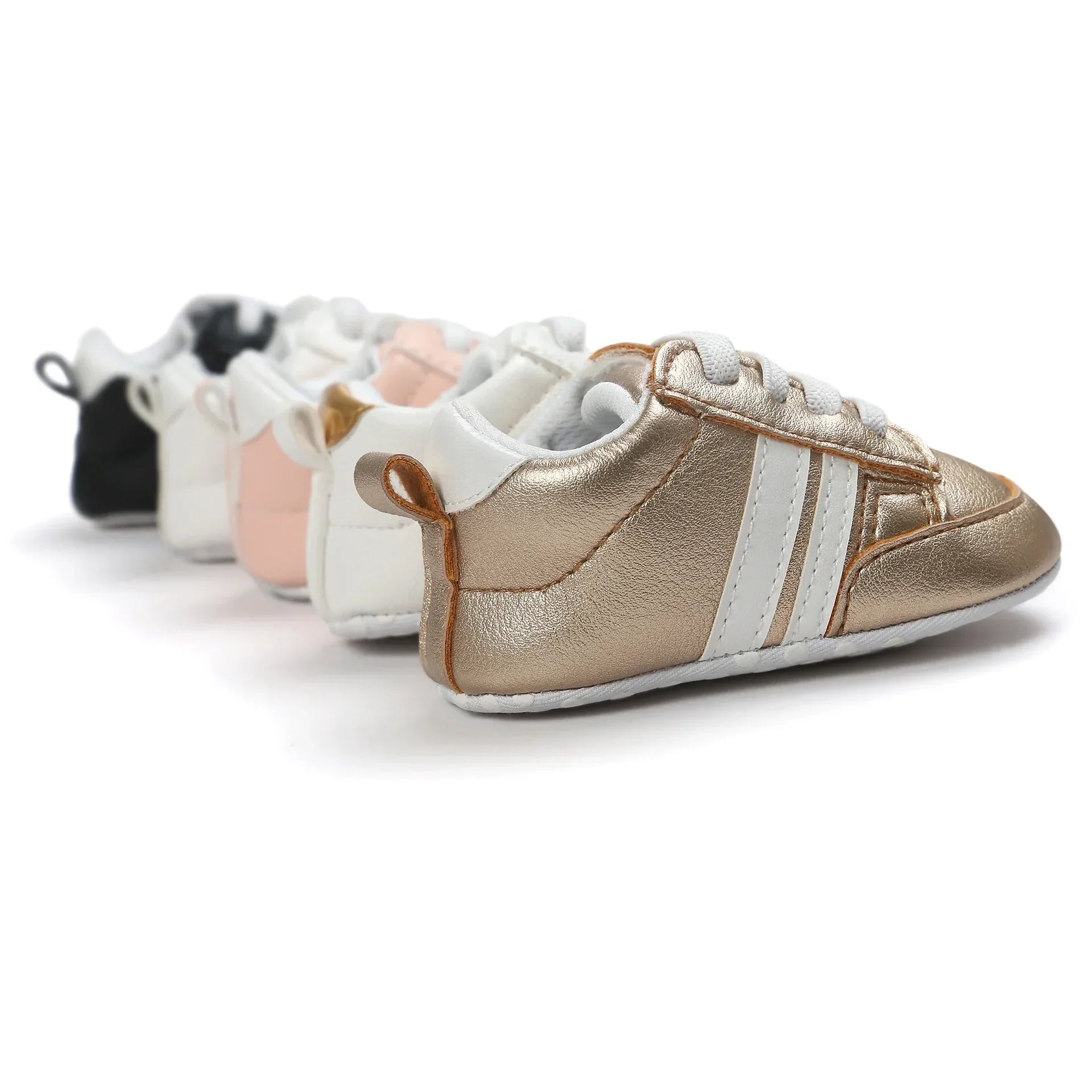 Assorted baby sneakers in gold, pink, white, and black, faux leather material, sporty style.