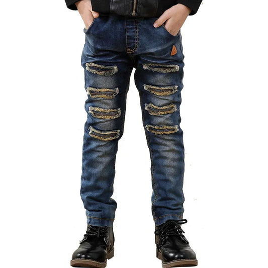 Blue slim-fit distressed denim jeans with ripped details and casual streetwear style.