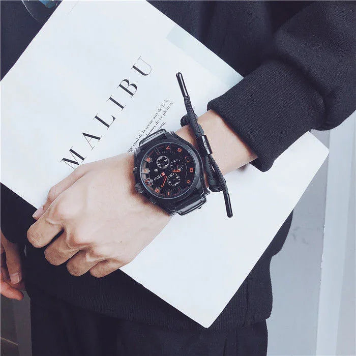 Black oversized sweatshirt with relaxed fit, paired with a black digital watch