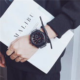 Black oversized sweatshirt with relaxed fit, paired with a black digital watch
