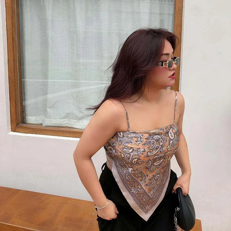 Woman wearing paisley print silk scarf top with spaghetti straps and relaxed fit