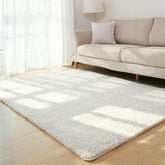 Modern living room with beige fabric sofa, fluffy white area rug, and light wood flooring