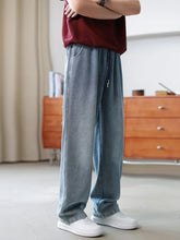 Wide-leg light blue denim jeans with relaxed fit, paired with white sneakers and a maroon top.