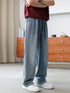 Wide-leg light blue denim jeans with relaxed fit, paired with white sneakers and a maroon top.