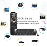 Black wireless air mouse remote with keyboard, USB dongle, and multi-device compatibility icons.