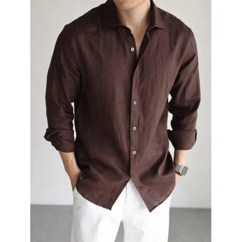 Men's casual brown linen button-up shirt with relaxed fit and long sleeves, paired with white pants.
