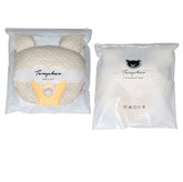 Cream textured bear-shaped pillow with packaging, soft plush material, cozy fit.