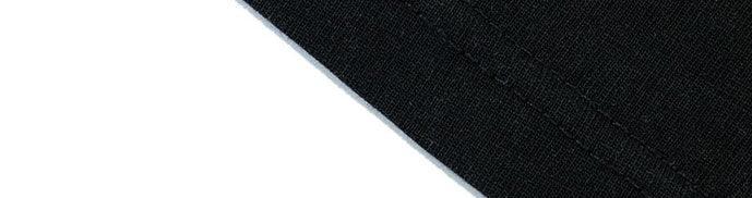 Close-up of black cotton streetwear fabric with visible stitching and clean seam
