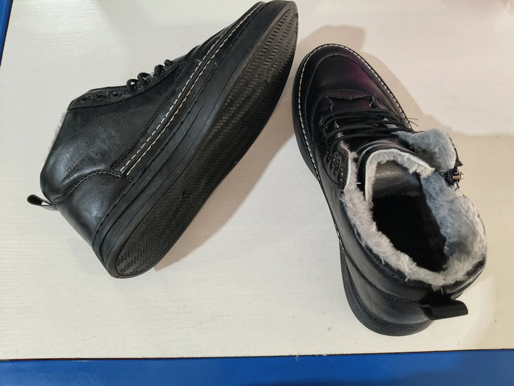 Black high-top sneakers with faux fur lining, leather material, chunky sole, streetwear style