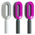 Modern oval hair brushes with ergonomic handles in gray and vibrant pink colors