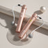Rose gold digital cordless jump rope with weighted handles and LED display on neutral background