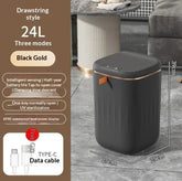 Black gold automatic trash can with drawstring style, UV sterilization, and 24L capacity in a modern room.