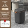 Black gold automatic trash can with drawstring style, UV sterilization, and 24L capacity in a modern room.