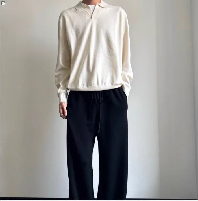 Minimalist outfit with a cream long sleeve knit top and loose black drawstring pants