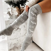 Gray knit over-the-knee socks with white snowflake and reindeer pattern, cozy fit.