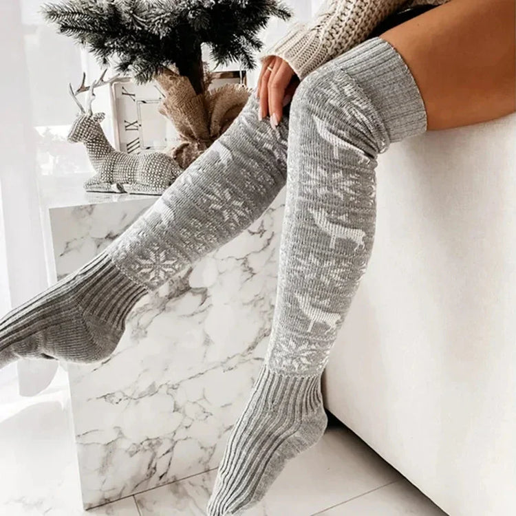 Gray knit over-the-knee socks with white snowflake and reindeer pattern, cozy fit.