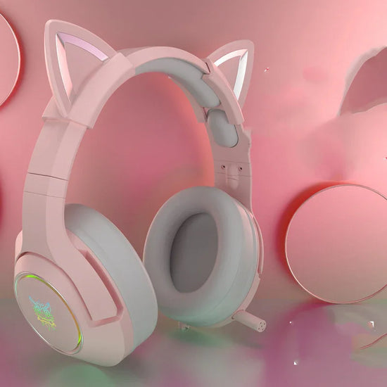Pink over-ear headphones with soft ear cushions and cat ear accents, matte finish