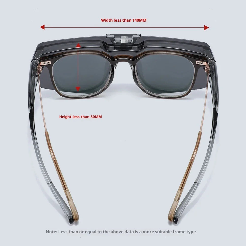 Futuristic rectangular sunglasses with dark lenses, clear black acetate frame, and gold metal arms.