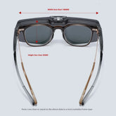 Futuristic rectangular sunglasses with dark lenses, clear black acetate frame, and gold metal arms.