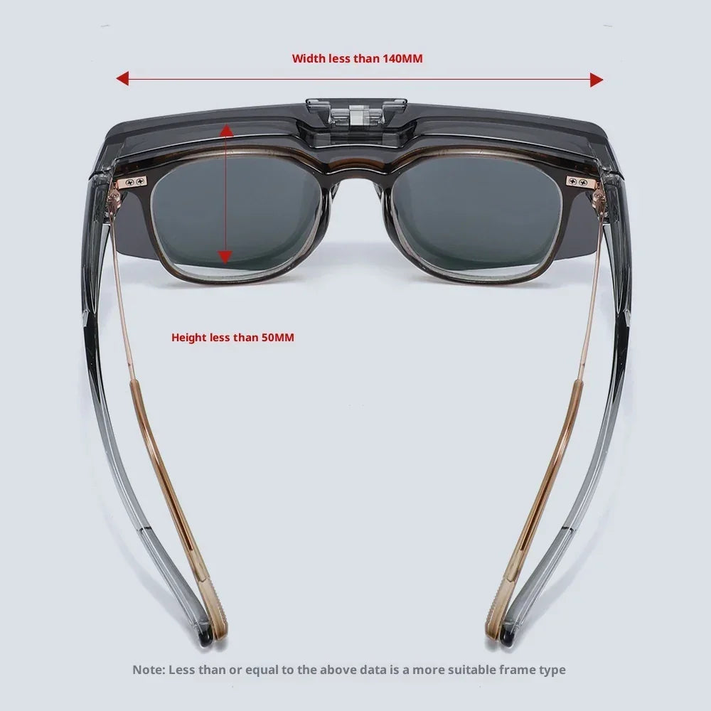 Futuristic rectangular sunglasses with dark lenses, clear black acetate frame, and gold metal arms.
