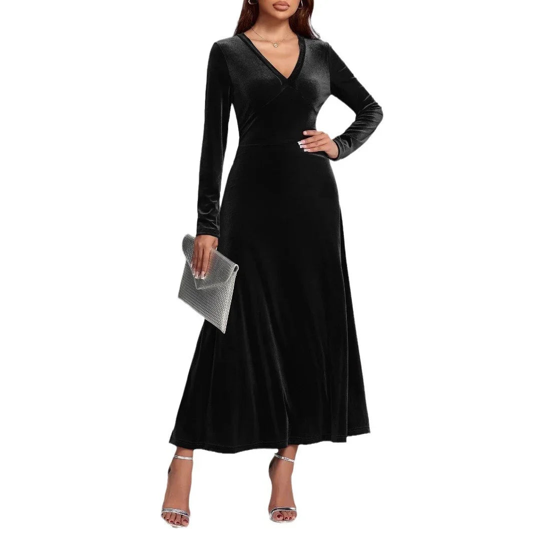 Woman wearing black velvet long-sleeve maxi dress with V-neck and fitted waist