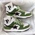 Green and white low-top suede sneakers with black star detail and white ribbed socks