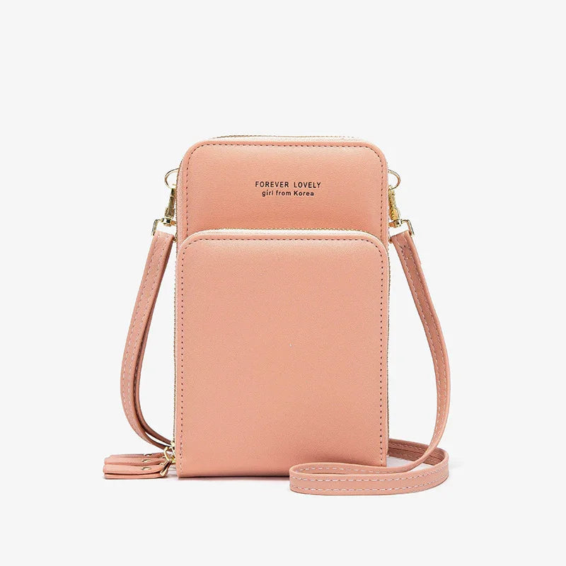 Pink faux leather crossbody bag with gold zippers, slim fit, minimalist streetwear style