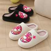 Cozy slip-on slippers in black and white with textured pink embroidered globe design, fleece material, indoor casual fit
