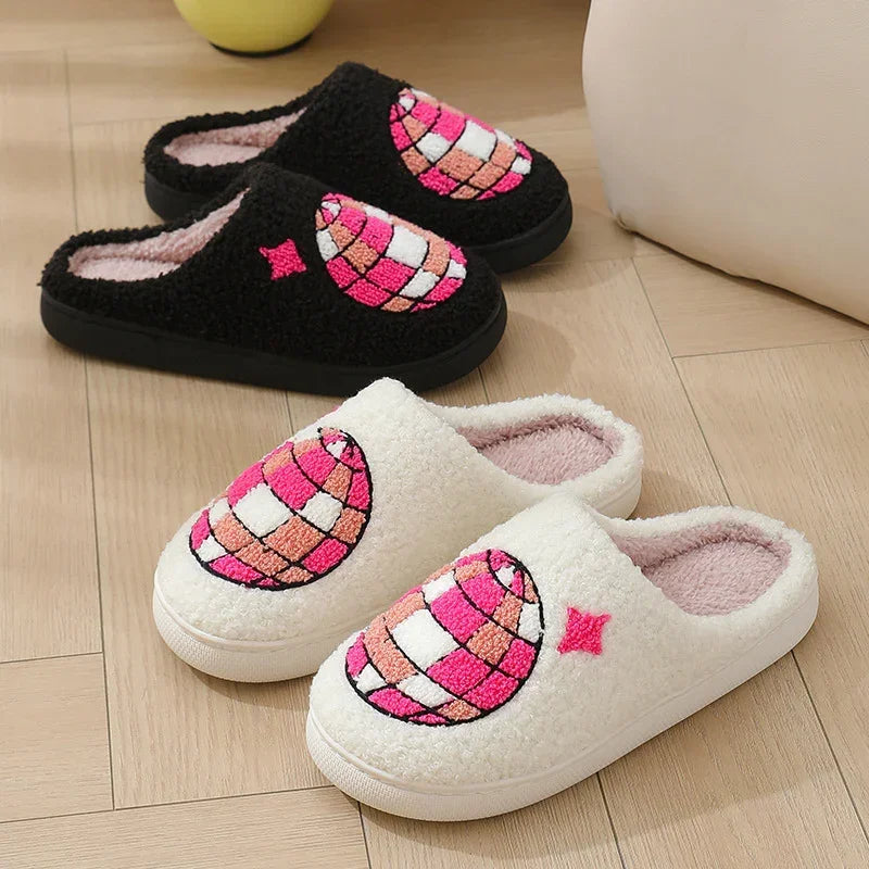 Cozy slip-on slippers in black and white with textured pink embroidered globe design, fleece material, indoor casual fit