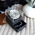 White preserved rose in clear acrylic box with drawer, containing beaded bracelets