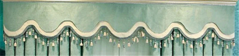 Light blue velvet window valance with scalloped edge and tassel trim, classic drapery style
