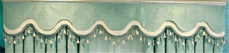 Light blue velvet window valance with scalloped edge and tassel trim, classic drapery style