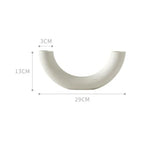 Curved white ceramic vase with matte finish, measuring 29cm wide and 13cm tall.