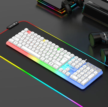 White RGB backlit mechanical keyboard with sleek design on a black gaming desk