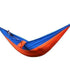 Two-tone blue and orange nylon hammock with person lying inside, relaxed fit, outdoor style
