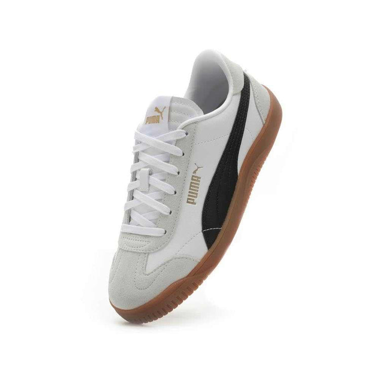 White low-top sneaker with black side stripe, suede accents, and gum rubber sole