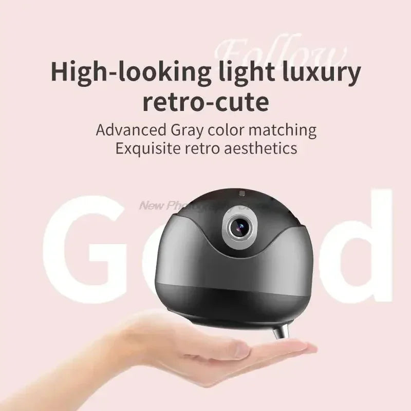 Hand holding a compact gray retro-style tech accessory with glossy finish.